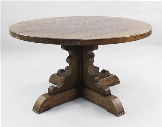 A large circular oak dining table, W.4ft 6in.